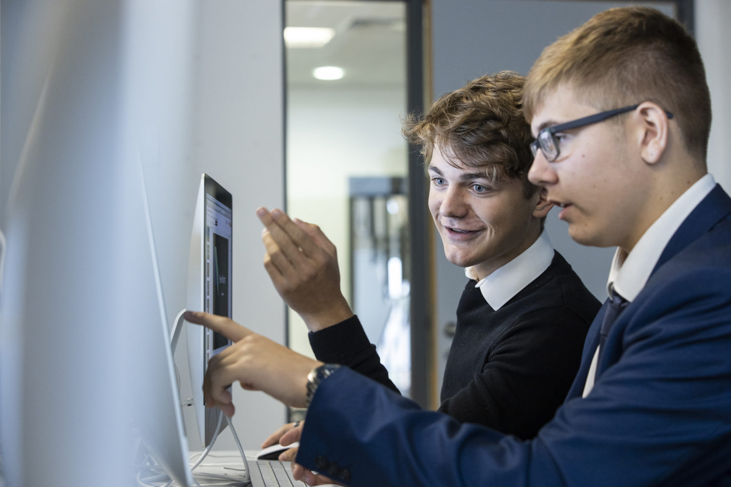 Two students working together on a computer